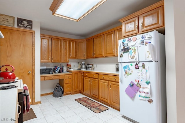 10393 Scotney Ave NW, North Canton, OH 44720 - kitchen featuring white appliances, light countertops, light tile patterned floors, and brown cabinets