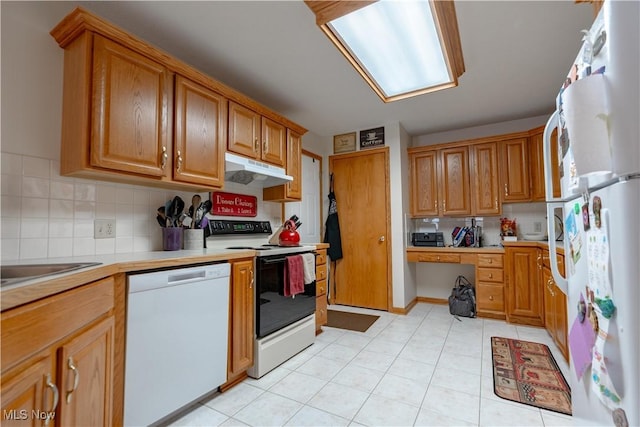 10393 Scotney Ave NW, North Canton, OH 44720 - kitchen with white appliances, under cabinet range hood, light countertops, backsplash, and brown cabinets