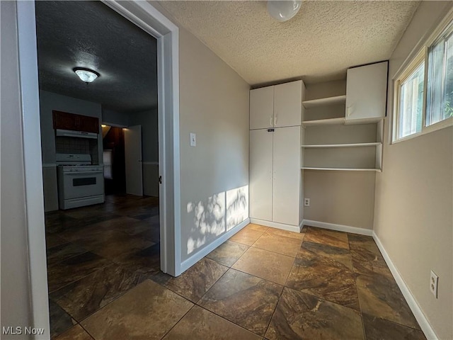 101 Ridgeway St, Struthers, OH 44471 - empty room with a textured ceiling and dark stone finish flooring