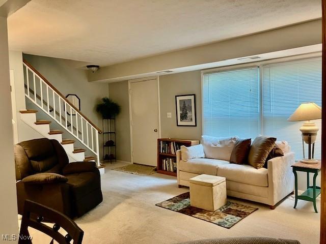 625 Canterbury Ln Unit 27A, Medina, OH 44256 - carpeted living area featuring stairs