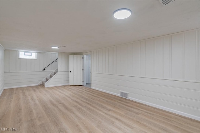 3886 Faversham Rd, University Heights, OH 44118 - below grade area with wood finished floors, stairs, and a decorative wall