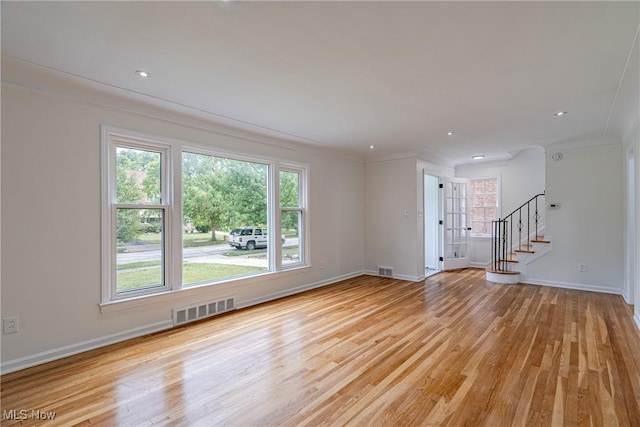 3886 Faversham Rd, University Heights, OH 44118 - unfurnished living room with crown molding, stairs, light wood-style floors, and recessed lighting