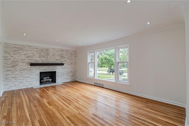 3886 Faversham Rd, University Heights, OH 44118 - unfurnished living room featuring crown molding, light wood-style floors, and a fireplace