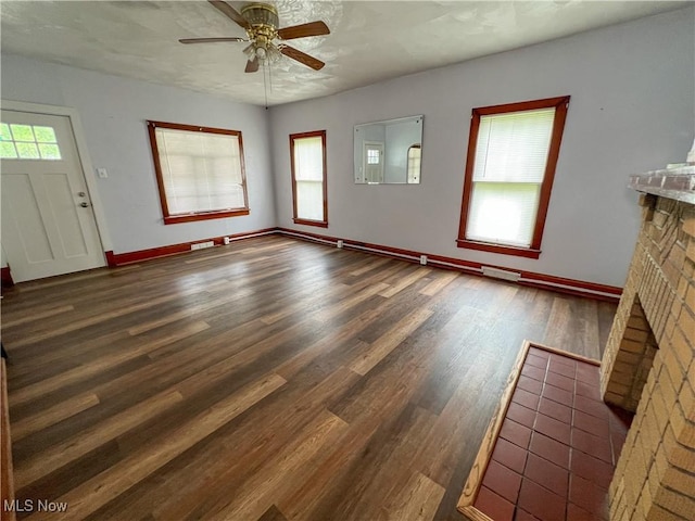 1874 Idaho Ave, East Liverpool, OH 43920 - unfurnished living room featuring a ceiling fan, wood finished floors, and a fireplace
