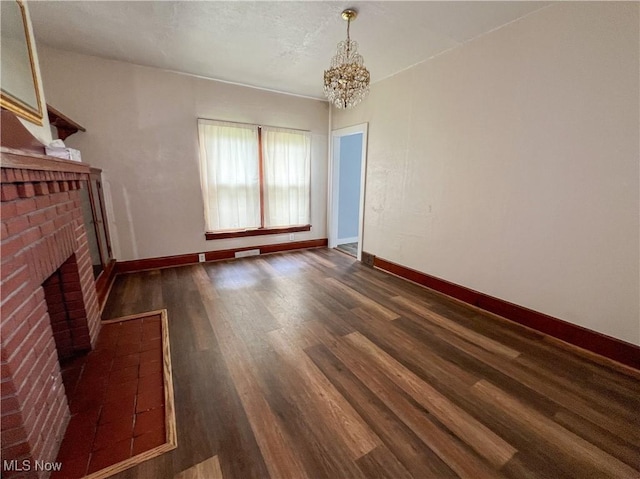 1874 Idaho Ave, East Liverpool, OH 43920 - unfurnished living room with a brick fireplace, dark wood-style floors, and a chandelier