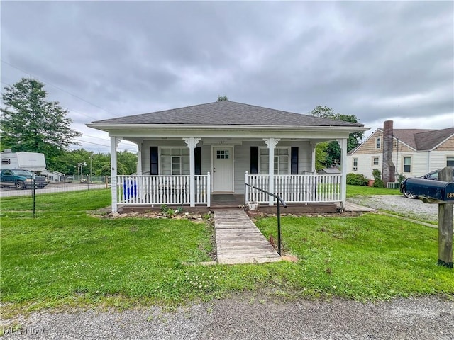 1874 Idaho Ave, East Liverpool, OH 43920 - bungalow-style home featuring covered porch, a front lawn, and roof with shingles