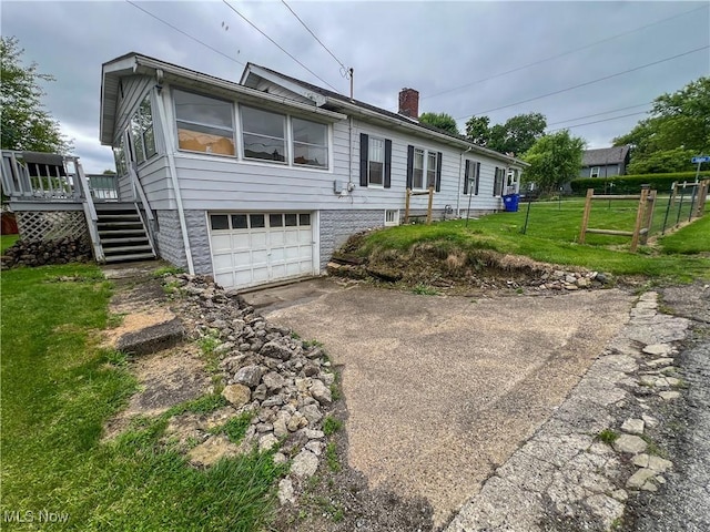 1874 Idaho Ave, East Liverpool, OH 43920 - rear view of property featuring driveway, a chimney, a garage, a wooden deck, and stairs