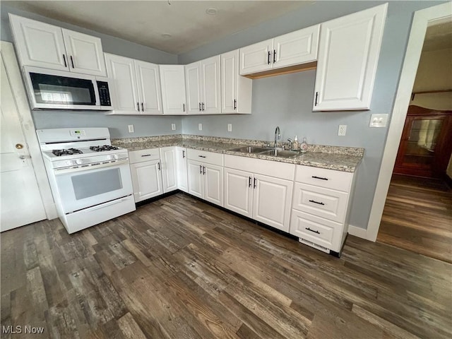 1874 Idaho Ave, East Liverpool, OH 43920 - kitchen featuring white range with gas stovetop, dark wood-style floors, white cabinetry, and light stone counters