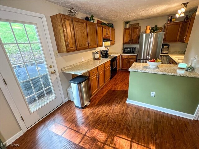 1714 Allison St, East Liverpool, OH 43920 - kitchen featuring black appliances, dark wood-style flooring, brown cabinets, a peninsula, and a textured ceiling