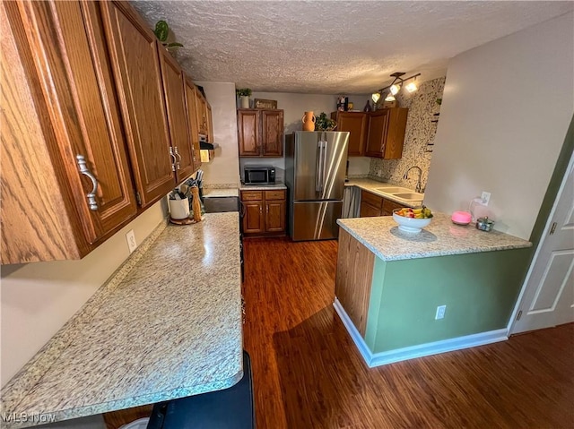 1714 Allison St, East Liverpool, OH 43920 - kitchen featuring freestanding refrigerator, black microwave, dark wood-style flooring, light countertops, and brown cabinets
