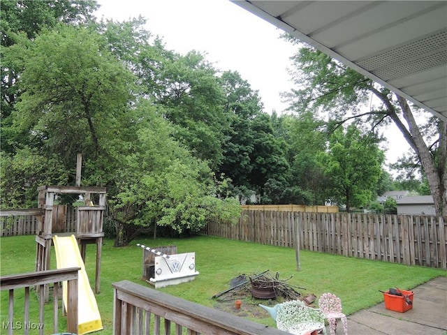 7277 Clovermeade Ave, Youngstown, OH 44514 - fenced backyard with a fire pit and a playground