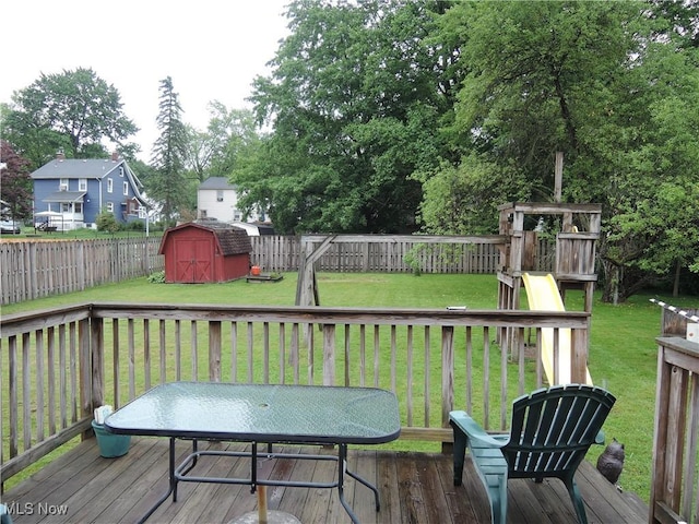 7277 Clovermeade Ave, Youngstown, OH 44514 - wooden deck with a shed, a fenced backyard, a playground, outdoor dining space, and a residential view