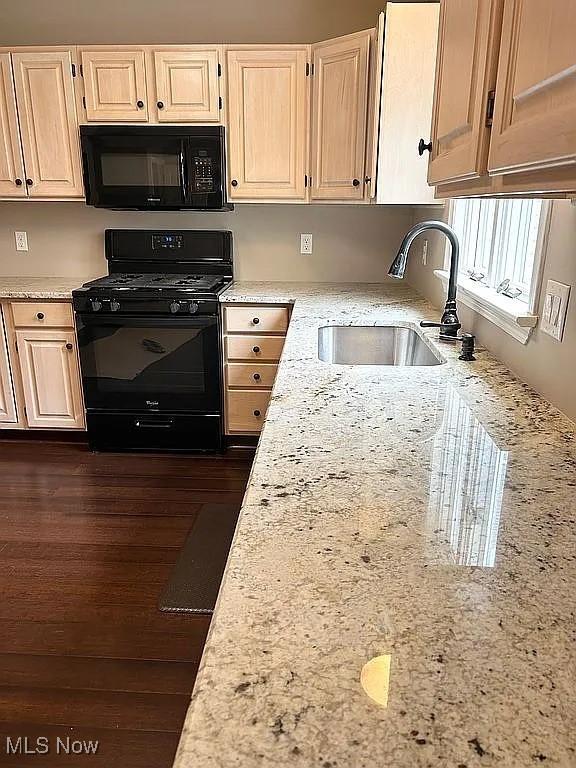 23 Fieldstone Dr, Poland, OH 44514 - kitchen with black appliances, light stone countertops, and dark wood finished floors
