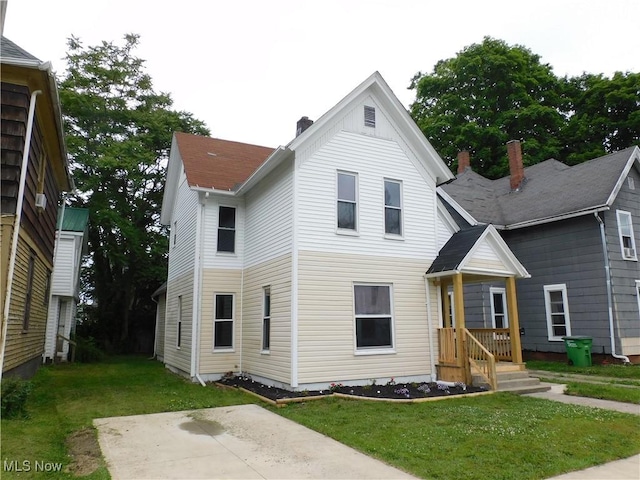 462 Monroe St, Conneaut, OH 44030 - traditional-style home featuring a front lawn, a chimney, and a patio
