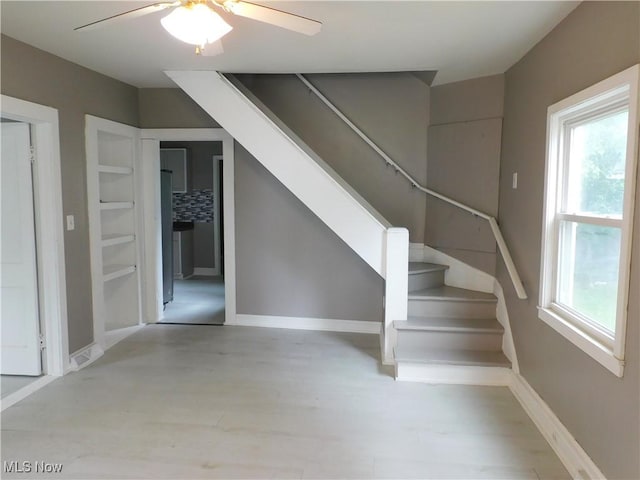 462 Monroe St, Conneaut, OH 44030 - staircase featuring a ceiling fan and wood finished floors