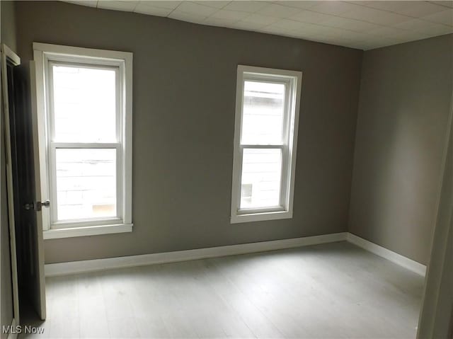 462 Monroe St, Conneaut, OH 44030 - empty room with healthy amount of natural light and wood finished floors