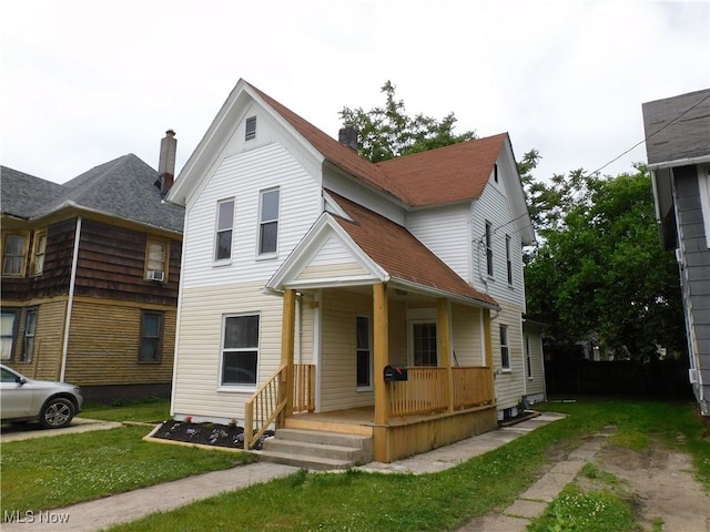 462 Monroe St, Conneaut, OH 44030 - view of front facade with a porch and a front lawn