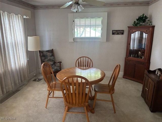 1051 Oakwood Ave NE, Massillon, OH 44646 - dining area with ceiling fan, light carpet, and ornamental molding