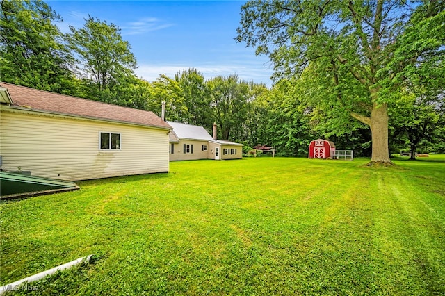 6136 Lake Rd W, Ashtabula, OH 44004 - view of green lawn with a storage unit
