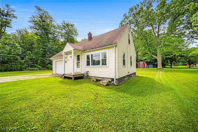 6136 Lake Rd W, Ashtabula, OH 44004 - bungalow-style house featuring a chimney, driveway, a front yard, a storage unit, and an attached garage