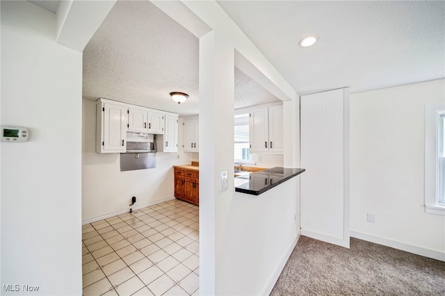 6136 Lake Rd W, Ashtabula, OH 44004 - kitchen featuring white cabinetry, a textured ceiling, recessed lighting, and light tile patterned floors