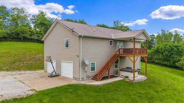 1448 Locust Ridge Rd, Washington, WV 26181 - rear view of property featuring a hot tub, a deck, concrete driveway, a metal roof, and a garage