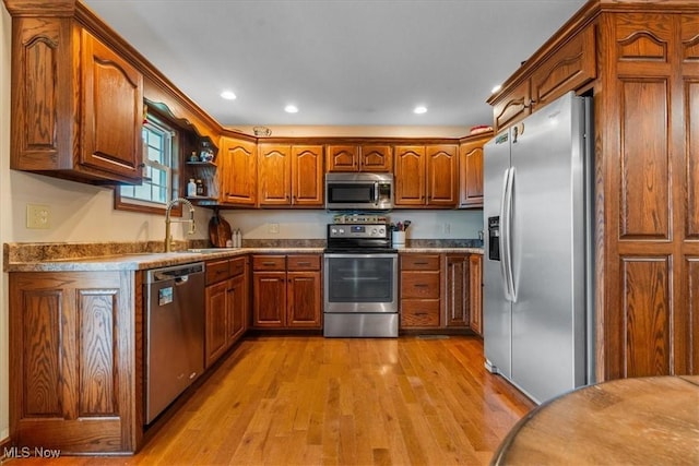 1448 Locust Ridge Rd, Washington, WV 26181 - kitchen with stainless steel appliances, brown cabinetry, light wood-type flooring, and recessed lighting