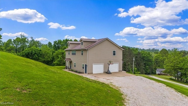 1448 Locust Ridge Rd, Washington, WV 26181 - view of home's exterior with driveway, a garage, and a lawn