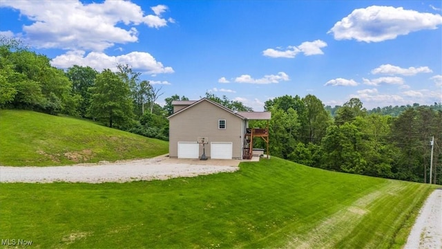 1448 Locust Ridge Rd, Washington, WV 26181 - view of side of home with a garage, dirt driveway, a lawn, and a deck