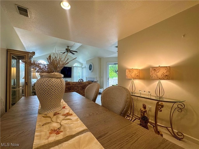 203 Willow Brook Dr NE, Warren, OH 44483 - dining room with lofted ceiling, a ceiling fan, a textured ceiling, and carpet flooring