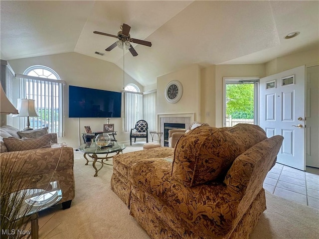 203 Willow Brook Dr NE, Warren, OH 44483 - living area with light carpet, a ceiling fan, lofted ceiling, and a tile fireplace