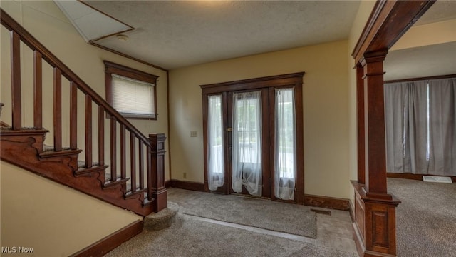 1515 Stewart Ave, Cambridge, OH 43725 - carpeted foyer featuring ornate columns, stairs, and a textured ceiling