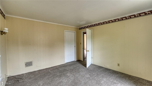 1515 Stewart Ave, Cambridge, OH 43725 - carpeted spare room featuring crown molding and wooden walls