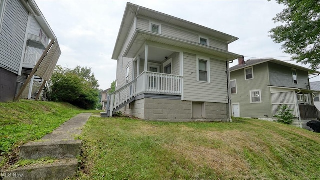 1515 Stewart Ave, Cambridge, OH 43725 - rear view of house featuring stairway, a yard, and covered porch