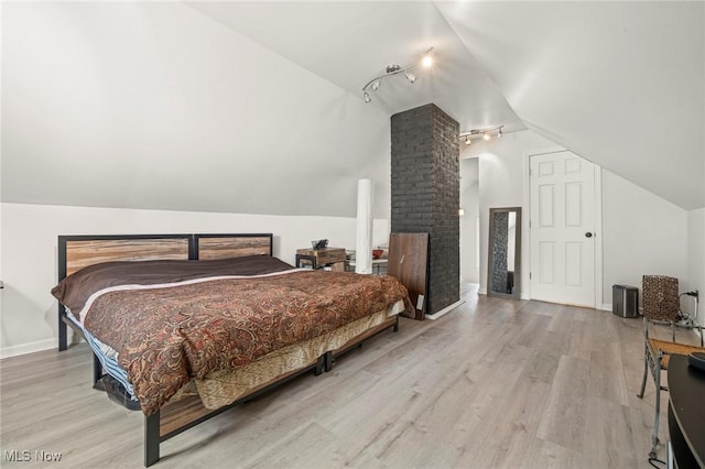 3846 Washington Blvd, University Heights, OH 44118 - bedroom featuring vaulted ceiling, rail lighting, and wood finished floors