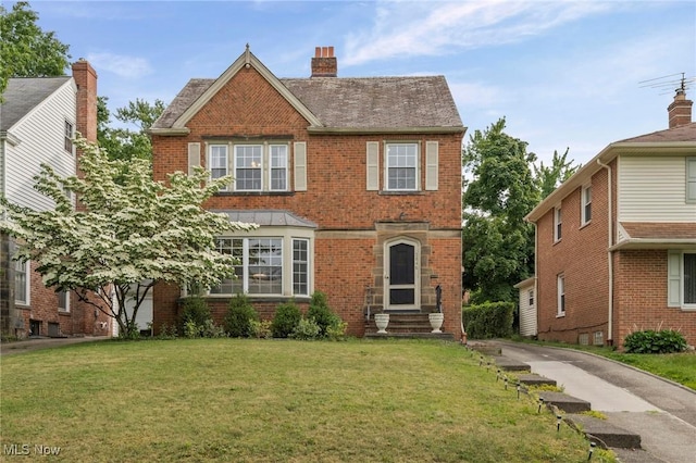 3846 Washington Blvd, University Heights, OH 44118 - traditional-style home featuring brick siding, a front yard, and a chimney