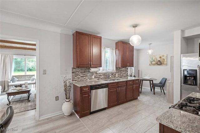 3846 Washington Blvd, University Heights, OH 44118 - kitchen with stainless steel appliances, backsplash, light stone countertops, and pendant lighting