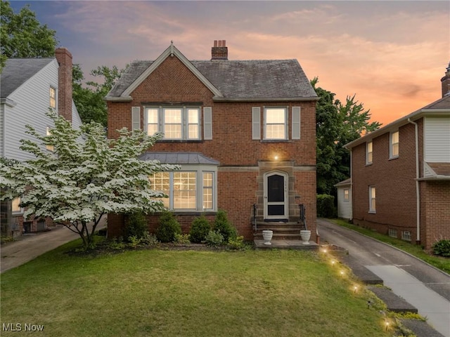 3846 Washington Blvd, University Heights, OH 44118 - traditional home with brick siding, a yard, and a chimney