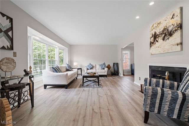 3846 Washington Blvd, University Heights, OH 44118 - living area featuring light wood-style flooring, arched walkways, recessed lighting, and a fireplace with flush hearth