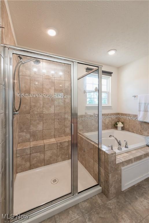 3478 Shadow Ledge Dr, Twinsburg, OH 44087 - full bathroom featuring a garden tub, a shower stall, and a textured ceiling