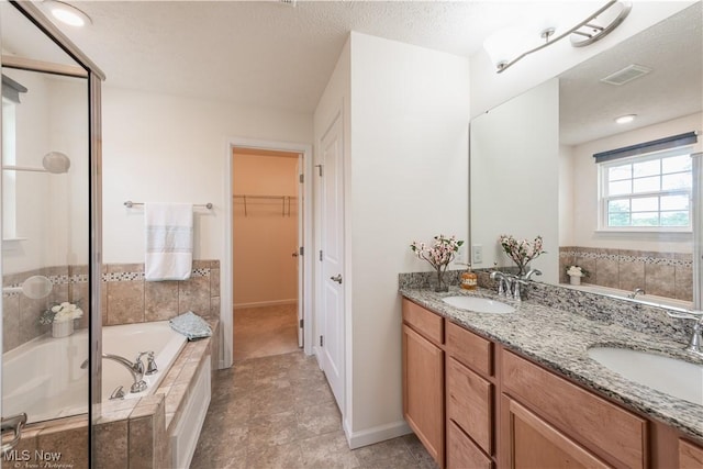 3478 Shadow Ledge Dr, Twinsburg, OH 44087 - bathroom featuring a garden tub, double vanity, a walk in closet, and a shower with shower door