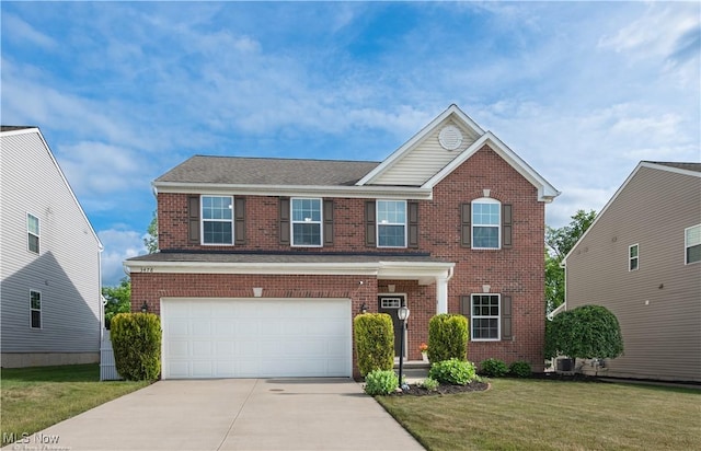 3478 Shadow Ledge Dr, Twinsburg, OH 44087 - view of front facade featuring an attached garage, concrete driveway, brick siding, and a front yard