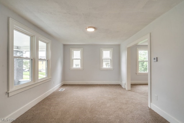 1617 Royal Ave NE, Canton, OH 44705 - spare room featuring light carpet and a textured ceiling