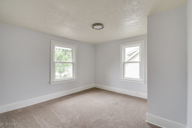 1617 Royal Ave NE, Canton, OH 44705 - carpeted empty room with a textured ceiling and baseboards