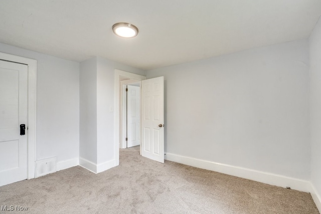 1617 Royal Ave NE, Canton, OH 44705 - spare room with light colored carpet and baseboards