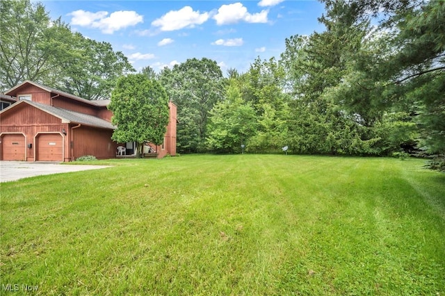 2709 Graham Rd, Stow, OH 44224 - view of grassy yard featuring an attached garage and driveway