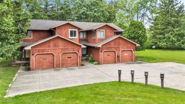 2709 Graham Rd, Stow, OH 44224 - view of front facade with driveway, a front yard, view of wooded area, and a garage