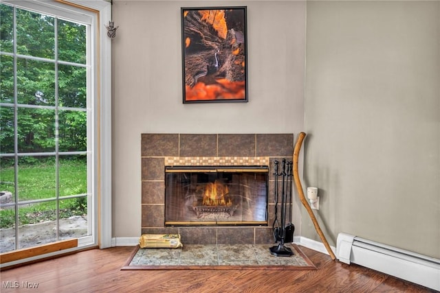 2709 Graham Rd, Stow, OH 44224 - detailed view of a baseboard radiator, wood finished floors, and a fireplace
