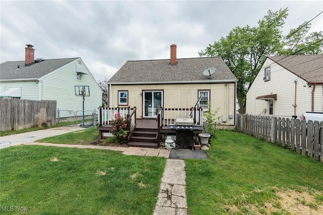 13112 Shady Oak Blvd, Garfield Heights, OH 44125 - rear view of house with a wooden deck, a fenced backyard, a chimney, and a shingled roof