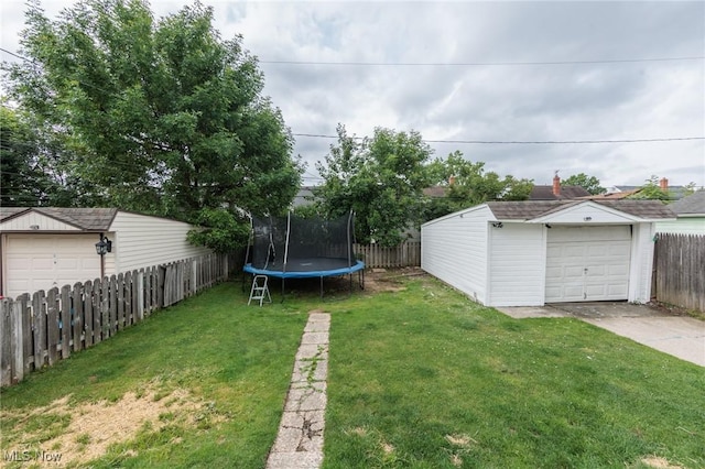 13112 Shady Oak Blvd, Garfield Heights, OH 44125 - fenced backyard with a trampoline, an outdoor structure, and driveway